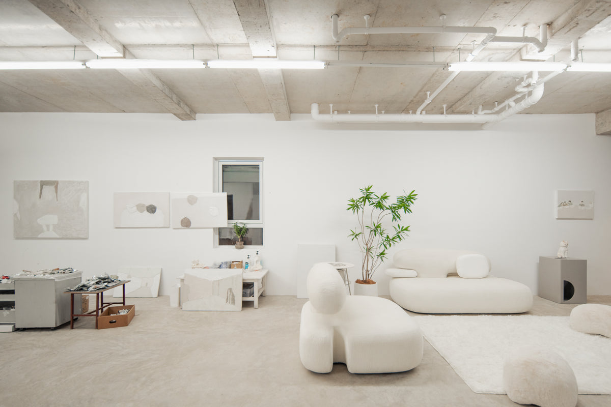 A light-filled interior with sculptural white sofas from the New Piece collection